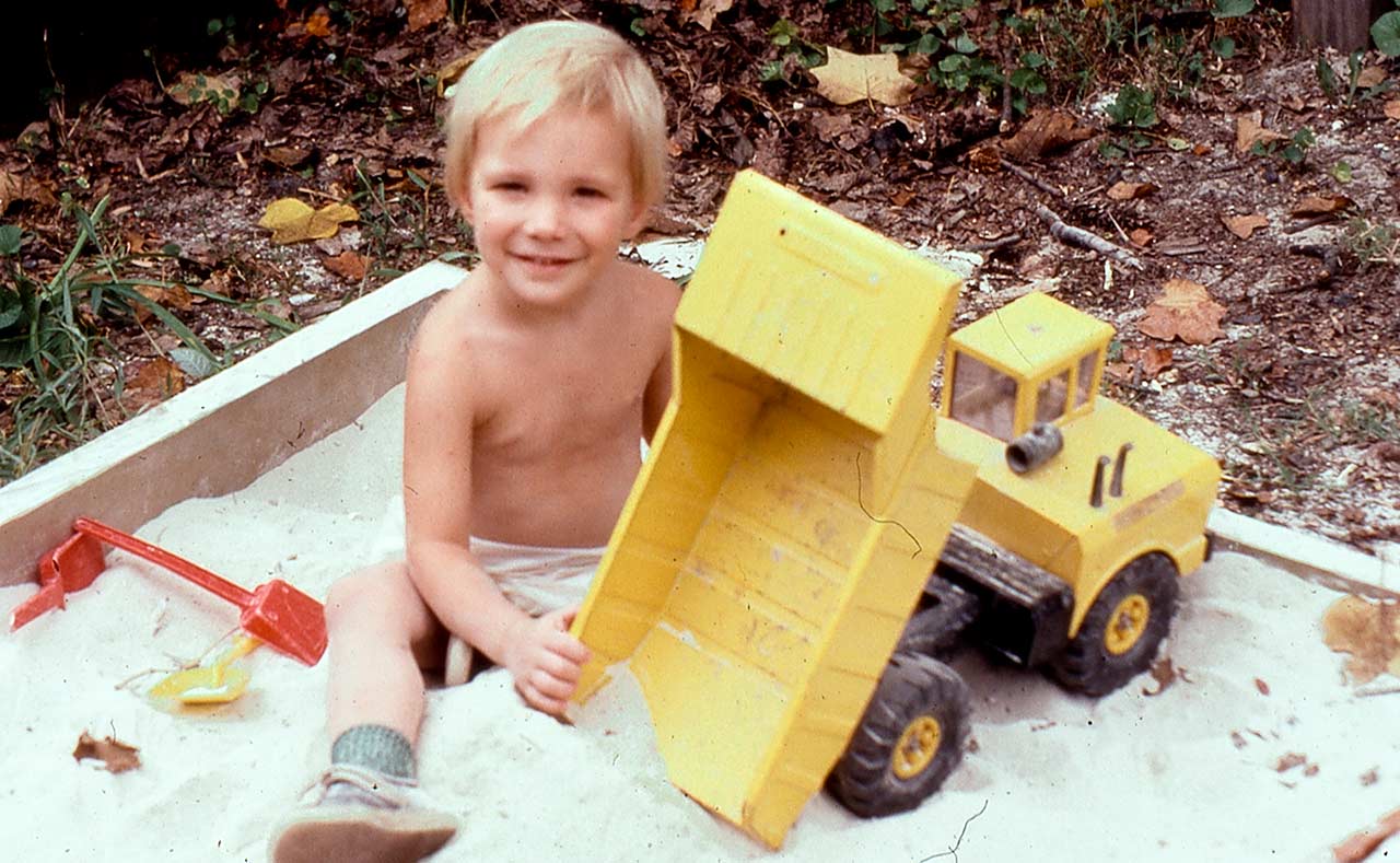 Eric playing in the sandbox with his Tonka dump truck